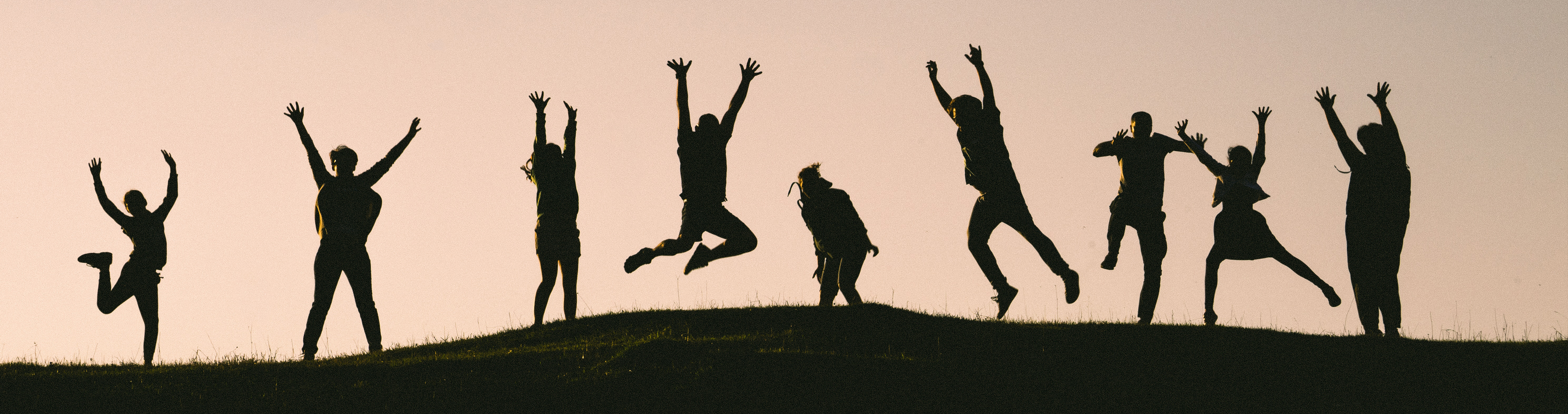 Silouhettes of people jumping
